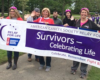 Heather Wright of New Middletown, center, walks among several hundred cancer survivors and supporters at the inaugural Mahoning County Relay for Life in Boardman Park on Saturday. Wright had her initial cancer diagnosis June 24, 2016. Doctors then said she had Stage IV metastatic breast cancer with cancer also spreading to all of her bones.
