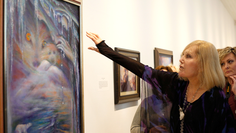 Actress and artist Kim Novak talks about her oil painting “Melting Glaciers” at the Butler Institute of American Art Trumbull Branch in Howland on Sunday. The painting depicts the devastating effects of climate change, Novak said.
