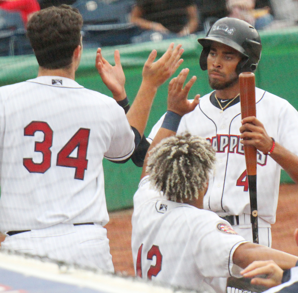 William D.Lewis  The Vindicator  Scrappers Michael Cooper(4.0 gets congrats from Ethan Hnakins(34) and George Valera(10 after scoring in first inning of game with Batavia 6-17-10 in Niles.
