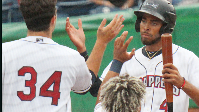 Michael Cooper, right, of the Mahoning Valley Scrappers, gets congratulations from teammates Ethan Hankins (34), and George Valera, after scoring in the first inning of game with the Batavia Muckdogs. The Scrappers won 3-1 in Monday's game at Eastwood Field in Niles.