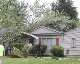  ROBERT K.YOSAY  | THE VINDICATOR..People from Warren to Brookfield are cleaning up after SundayÕs damaging winds after learning that the mess indeed was created by a tornado and possibly a series of touchdowns...the trees still on a house..that knocked down the awning and took out electric in warren Tod Ave area