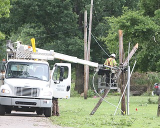  ROBERT K.YOSAY  | THE VINDICATOR..People from Warren to Brookfield are cleaning up after SundayÕs damaging winds after learning that the mess indeed was created by a tornado and possibly a series of touchdowns...Triple D contractors work to replace a pole and electric on Kincaid East Rd NW