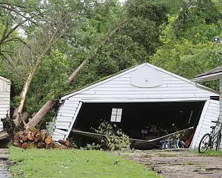  ROBERT K.YOSAY  | THE VINDICATOR..People from Warren to Brookfield are cleaning up after SundayÕs damaging winds after learning that the mess indeed was created by a tornado and possibly a series of touchdowns...in the 200  Block of Tod Lane a garage felt the impact from the fallen trees and wind