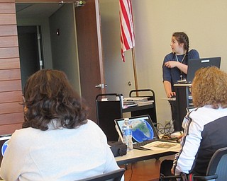 Neighbors | Jessica Harker.Hannah Matulek, a librarian at the Michael Kusalaba branch, demonstrated different features of the Google Earth program to community members April 23 in celebration of Earth Day.