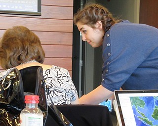 Neighbors | Jessica Harker.Librarian Hannah Matulek helped community members navigate the free Google Earth Program April 23 at the Michael Kusalaba library's Earth Day event.