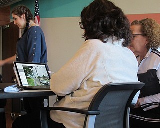 Neighbors | Jessica Harker.Community members used laptops provided by the library to explore the globe using the Google Earth Program to celebrate Earth Day April 23.