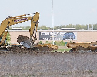  A dozen or more pieces of equipment are moving earth at the future HomeGoods/TJX distribution center at Ellsworth Bailey and Hallock Young roads in Lordstown. 