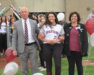 Neighbors | Jessica Harker.Boardman superintendent Tim Saxton and his wife walk their daughter, Ashley Saxton, onto the field during the softball team's annual senior night on April 29.