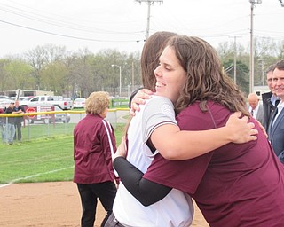 Neighbors | Jessica Harker .Senior softball players at Boardman High School hugged members of the school and coaching staff on April 29 at the team's senior night celebration.