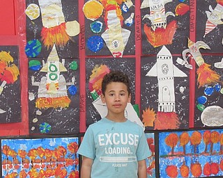 Neighbors | Jessica Harker.Dearies Douglas posed next to his art work May 7 at Austintown Elementary School's annual Second Grade Art Show.