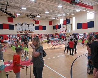 Neighbors | Jessica Harker.Community members gathered at AES May 7 for the schools showcase of second grade art.