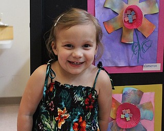 Neighbors | Abby Slanker.Canfield United Methodist Preschool 3-year-old class student Cameron Doan was all smiles as she checked out her Colorful Carnations art project at the school’s annual art show on May 9.
