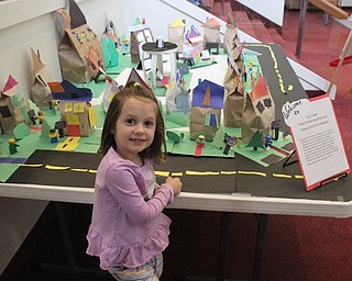 Neighbors | Abby Slanker.Canfield United Methodist Preschool pre-k class member Aubrey Shapona stood by her house that she created for the Family Neighborhood class project at the school’s annual art show on May 9.