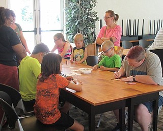 Neighbors | Jessica Harker .Children worked on decorating their own whool spinning tools June 12 at the Austintown library's first sheep sheering demonstarion event.