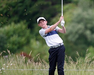 Conor Daggett, 14, of Canfield, watches after he hits the ball during the Greatest Golfer junior qualifiers at Reserve Run Golf Course on Thursday. EMILY MATTHEWS | THE VINDICATOR