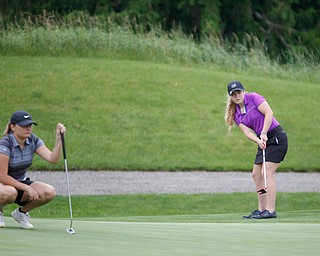 Sophia Yurich, right, 15, of Poland, puts the ball while Alyssa Rapp, 15, of Cardinal Mooney, watches during the Greatest Golfer junior qualifiers at Reserve Run Golf Course on Thursday. EMILY MATTHEWS | THE VINDICATOR