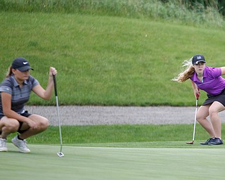 Sophia Yurich, right, 15, of Poland, reacts as she watches the ball after putting it while Alyssa Rapp, 15, of Cardinal Mooney, watches during the Greatest Golfer junior qualifiers at Reserve Run Golf Course on Thursday. EMILY MATTHEWS | THE VINDICATOR