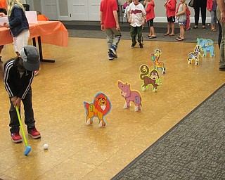 Neighbors | Jessica Harker .Children played six holes of mini golf at the Canfield library on June 13 celebrating the upcoming opening of the new "Lion King" movie.