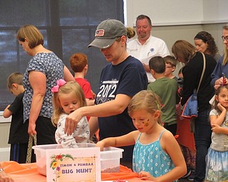 Neighbors | Jessica Harker .Children dug through sand looking for plastic bugs at the Canfield library for the Safari Party celebrating the upcoming release of the live action "Lion King" movie.