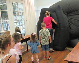 Neighbors | Jessica Harker .Children and their families entered the portal planetarium set up at the Poland library, fitting this year's theme of the summer reading program, "A Universe of Stories."