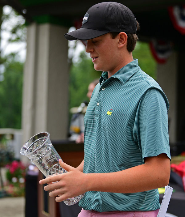 BOARDMAN, OHIO - JUNE 20, 2019: Jackson Finney, of Louisville, Kentucky, smiles after receiving his championship trophy after the completion of the final round of the American Junior Golf Association Tournament. DAVID DERMER | THE VINDICATOR