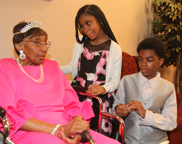 William D. Lewis The Vindicator Rev. Flonerra Henry-Harris shares a moment with two of her great grandchildren, Mercedes Spencer and her brother Elijah Spencer 13, of Youngstown. A 100th birthday party for Rev. Henry -Harris was held at Mahoning Country Club in Girard 6-21-19.