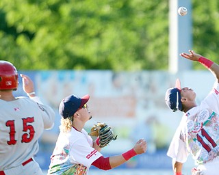 Brayan Rocchio of the Mahoning Valley Scrappers grabs the ball with Raynel Delgado behind him as Auburn Doubledays' Jack Dunn runs to second base during their game Friday night at Eastwood Field. The Doubledays beat the Scrappers 8-1.