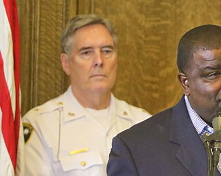 Youngstown Mayor Jamael Tito Brown makes comments about 'Operation Steel Penguin,' a joint effort by law enforcement on the local, state and federal level that took 33 guns off Youngstown streets and resulted in four federal indictments. In the background is police Chief Robin Lees.