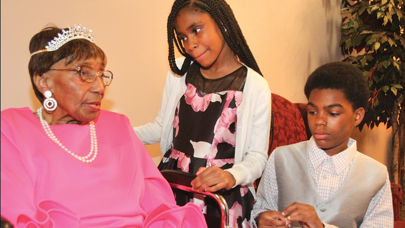 The Rev. Flonerra Henry-Harris shares a moment with two of her great grandchildren, Mercedes Spencer, 12, and her brother Elijah Spencer 13, both of Youngstown. A 100th birthday party for Rev. Mrs. Henry-Harris was Friday at Mahoning Country Club in Girard.