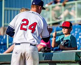 DIANNA OATRIDGE | THE VINDICATOR Mahoning Valley Scrapper Brendan Meyer fist bumps Aiden Auchter, age 7, from Warren, before Saturday night's game against Auburn at Eastwood Field.