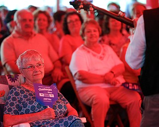Joyce Franklin, of Brookfield, listens to music played by Bill Lewis at Warren Chautauqua on Tuesday evening. Franklin says she tries to go to the Chautauqua events whenever she can and travels to other areas to see them when they are not held in Warren. EMILY MATTHEWS | THE VINDICATOR