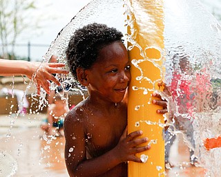 Mason Moore, 6, who attends Daycare Storybook, plays under the water at the water park in the James L. Wick, Jr. Recreation Area in Mill Creek Park on Thursday. The daycare went to the park today to cool off and enjoy the weather. EMILY MATTHEWS | THE VINDICATOR