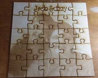 Neighbors | Submitted.Using a laser engraver community members created puzzles depicting what ever image they chose at the Michael Kusalaba library's Laser Cut Puzzles event.