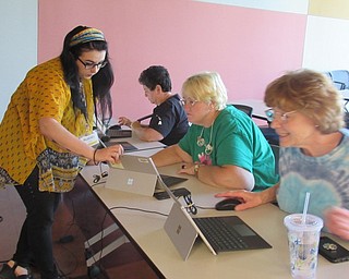 Neighbors | Jessica Harker.Librarian Hannah Matulek assisted community members with designing their puzzles May 11 at the Michael Kusalaba library's Laser Cut Puzzle event.