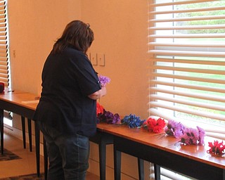 Neighbors | Jessica Harker .Community members chose from a variety of flowers to add to their string vase art work.