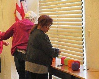 Neighbors | Jessica Harker .Community members chose from a number of colored strings available at the Austintown library to create a piece a string art.
