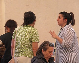 Neighbors | Jessica Harker .Librarian Renee Beverly explained to community members how to create a string vase at the Austintown library on May 6.