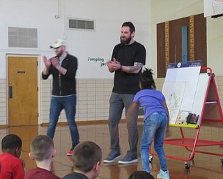 Neighbors | Jessica Harker.Serenity Parker walked like Godzilla during Chris Stanley and Alex LeVasseur's presentation at Market Street Elementary School's celebration of Right to Read week.