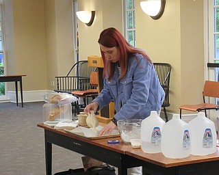 Neighbors | Jessica Harker.Missy Williams mixed dough with flour, demonstrating for community members how to lay it on their baking sheets May 20 at the Poland library's No Need to Knead bread dough making event.