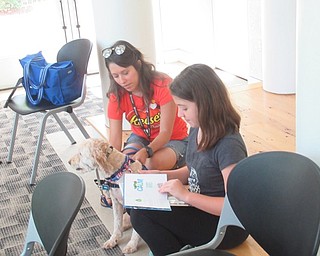 Neighbors | Jessica Harker .Children were able to choose from a number of books to read to volunteer Dana Patrick and her therapy dog, Reese, at the Austintown library.