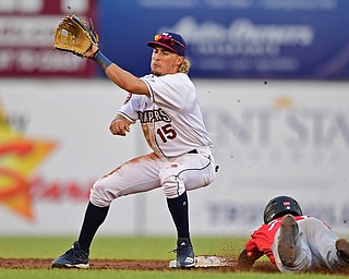 NILES, OHIO - JUNE 28, 2019: Scrappers' Ray Delgado looks the ball into his glove as Muckdogs' JD Orr steals second base in the third inning of their game against the Batavia Muckdogs, Friday night at Eastwood Field. DAVID DERMER | THE VINDICATOR