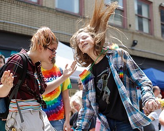 Ely Kendall, 15, of Boardman, left, and Avery Hodgson, 14, of Trevor, Wisconsin, dance at the 11th annual Pride parade and festival in downtown Youngstown on Saturday afternoon. EMILY MATTHEWS | THE VINDICATOR