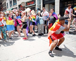 Teaunia Jenkins, of Youngstown, dances with the crowd at the 11th annual Pride parade and festival in downtown Youngstown on Saturday afternoon. EMILY MATTHEWS | THE VINDICATOR