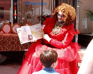 Esther Gin, a performer from Alliance, reads A Day in the Life of Marlon Bundo by Jill Twiss at the 11th annual Pride parade and festival in downtown Youngstown on Saturday afternoon. EMILY MATTHEWS | THE VINDICATOR