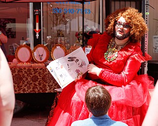 Esther Gin, a performer from Alliance, reads A Day in the Life of Marlon Bundo by Jill Twiss at the 11th annual Pride parade and festival in downtown Youngstown on Saturday afternoon. EMILY MATTHEWS | THE VINDICATOR