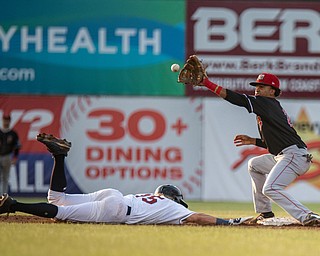 DIANNA OATRIDGE | THE VINDICATOR Mahoning Valley's Raynel Delgado (15) slides back to second base on a pick off attempt as Batavia's Gerardo Nunez makes the catch during their game at Eastwood Field on Saturday night.
