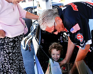 PDRA world champion Tom Martino, of Youngstown, right, helps Robert "Obie" Alden, 4, of Niles, get into his Top Dragster while Alden's grandmother Patty Butler, of Niles, watches nearby at the Mahoning Valley Corvette Club's 25th Annual Corvette and Steel Car Show at Greenwood Chevrolet in Austintown on Sunday. EMILY MATTHEWS | THE VINDICATOR