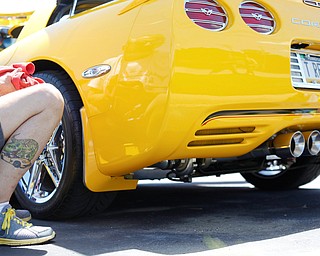 Rex Swortzbeck, of Greenville, Pa., finishes putting a chrome plate behind one of the wheels of his 2003 Chevrolet Corvette at the Mahoning Valley Corvette Club's 25th Annual Corvette and Steel Car Show at Greenwood Chevrolet in Austintown on Sunday. EMILY MATTHEWS | THE VINDICATOR