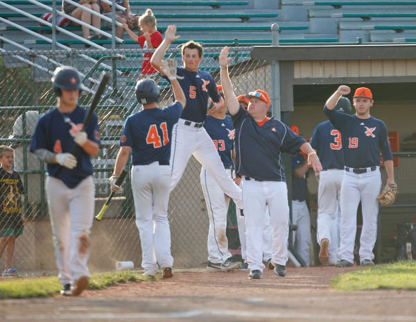 The Astro Falcons celebrate after scoring in the first inning of their game against the Stark County Terriers at Bob Cene Park on Sunday. EMILY MATTHEWS | THE VINDICATOR