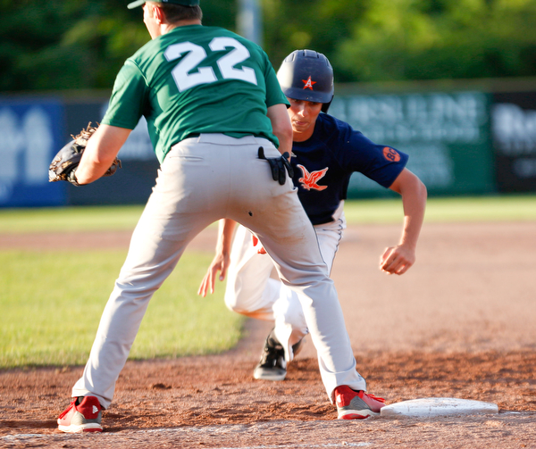 The Astro Falcons' Lucas Gulczynski runs back to first before the Stark County Terriers' Dalton Frey could tag him during their game at Bob Cene Park on Sunday. EMILY MATTHEWS | THE VINDICATOR
